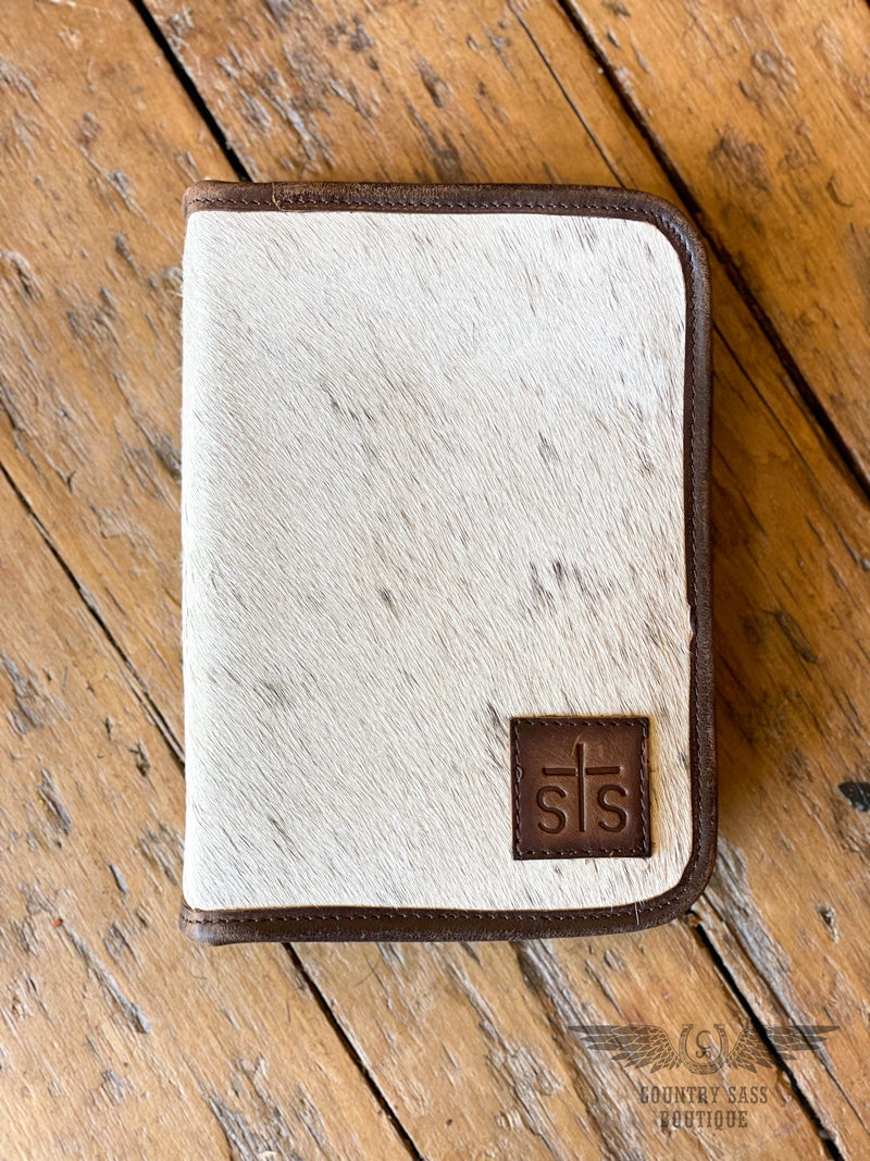 Picture of front of jewelry case that is white cowhide with an STS leather patch on front.