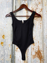 Photo of front view of black bodysuit on clothes hanger