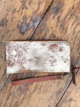 Photo of back of metallic gold leather wallet clutch with wrist strap