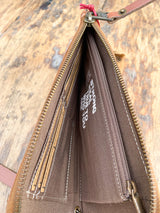 Photo of inside of clutch with fabric liner card slots and zipper divider and inspirational quote printed on the inside