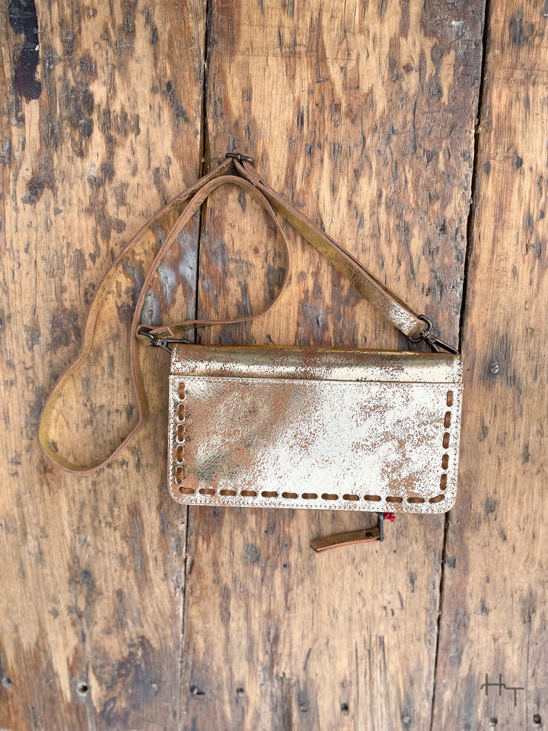 Photo of metallic gold leather purse with crossbody strap