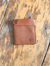 Photo of front of brown leather boot wallet with front strap and snap on wood background