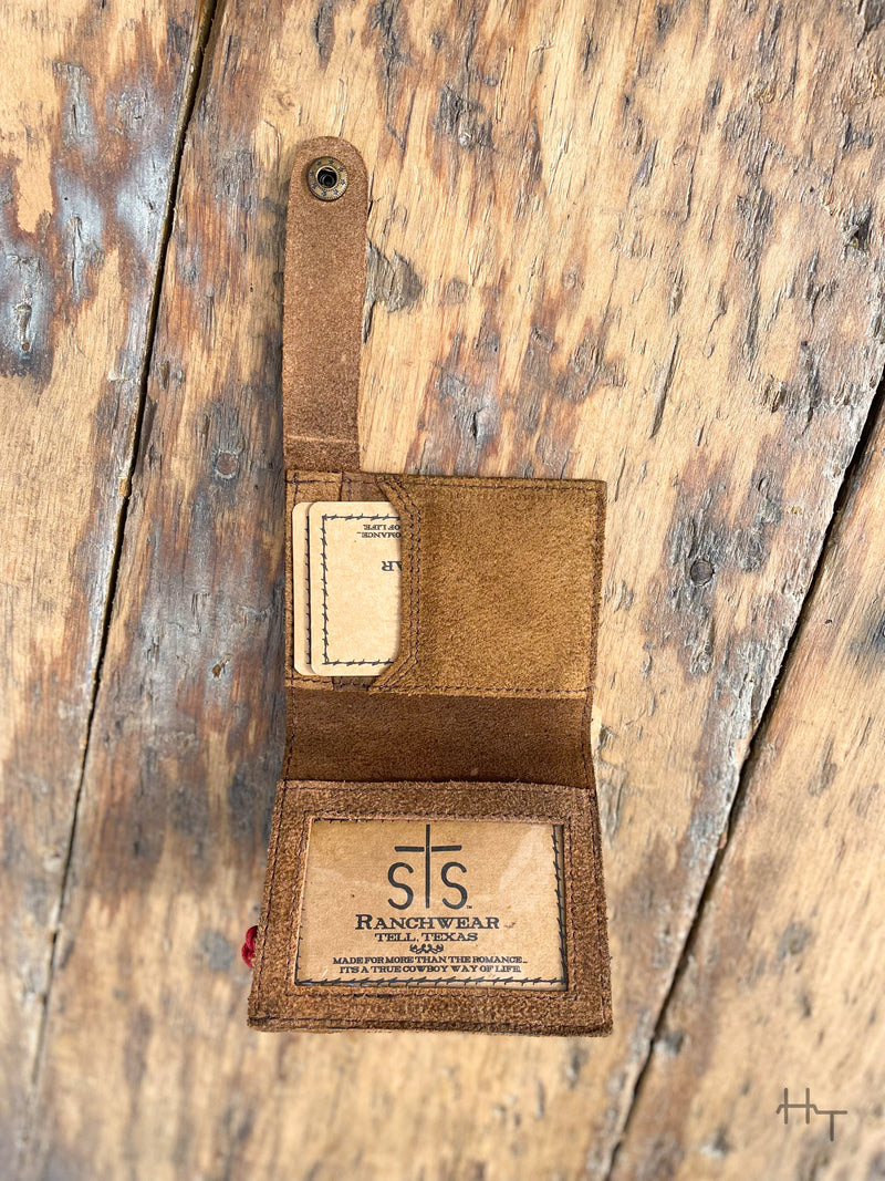 Photo of inside of brown leather boot wallet with strap and snap closure 1 clear id slot and 2 card slots with wood background