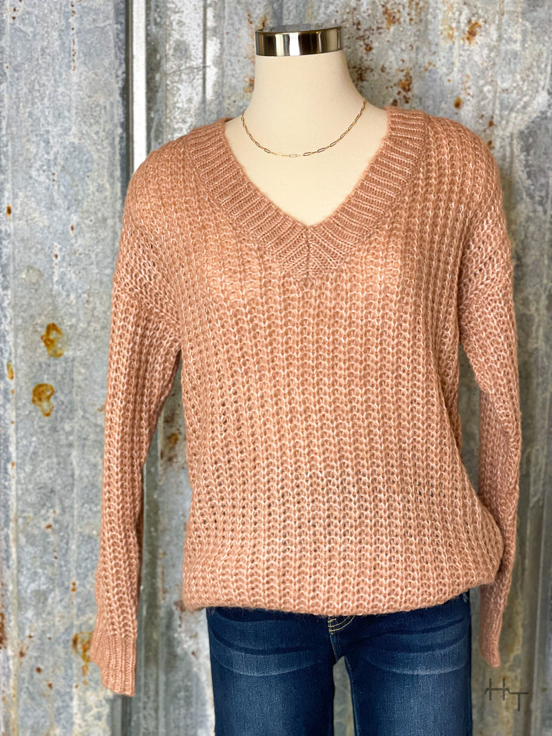 Photo of light rose pink knit v neck sweater on mannequin with tin background