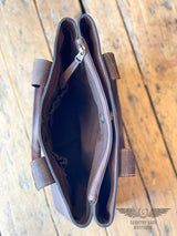 Picture of one of the 3 inside compartments of the westward tote.  Image shows 2 elastic slip pockets and magnetic closure.